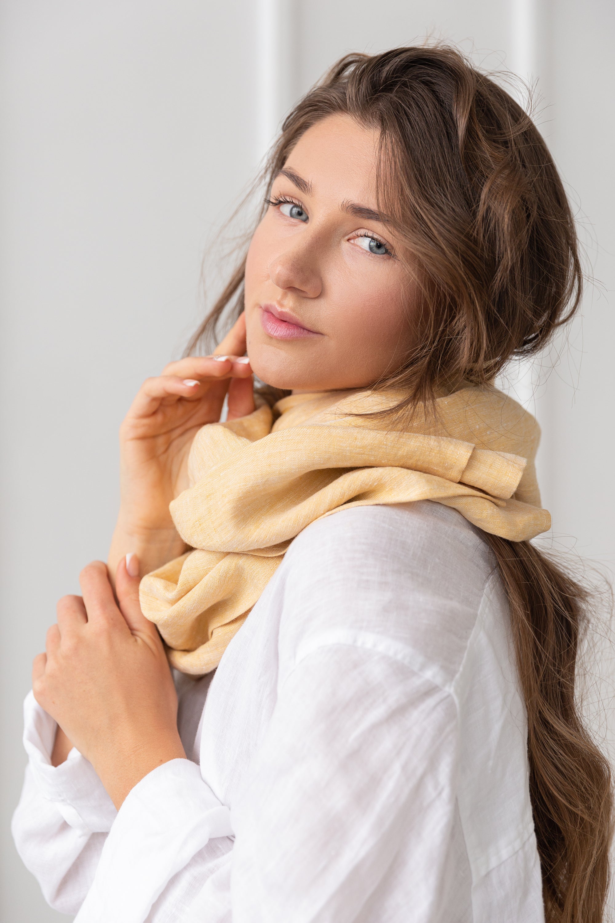 A stylish reddish brown linen scarf made from 100% stonewashed linen, showcasing its soft texture and elegant design.