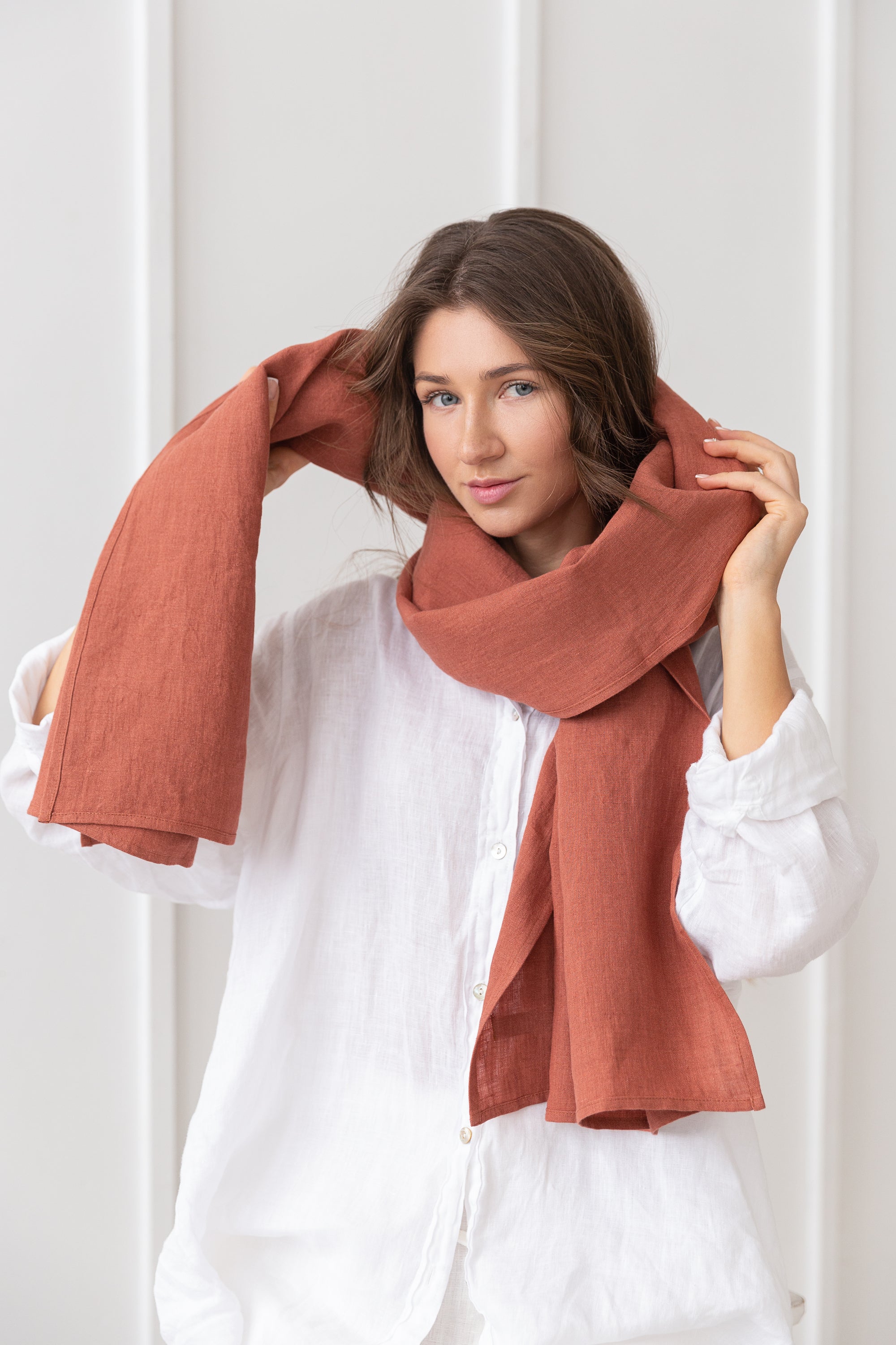 A stylish reddish brown linen scarf made from 100% stonewashed linen, showcasing its soft texture and elegant design.