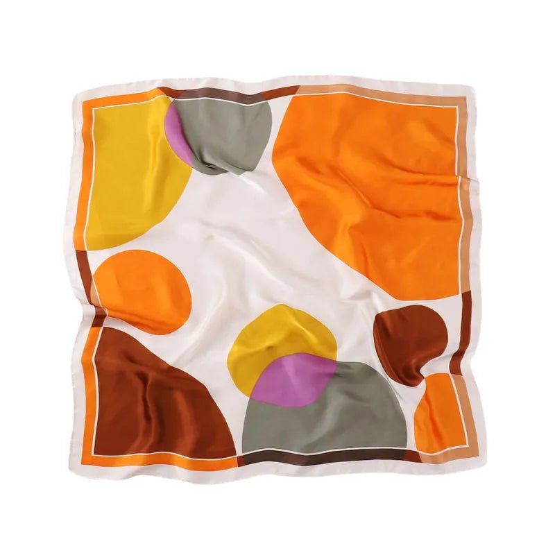 A vibrant silk scarf in rich fall colors, elegantly displayed, showcasing its luxurious texture and versatile design.