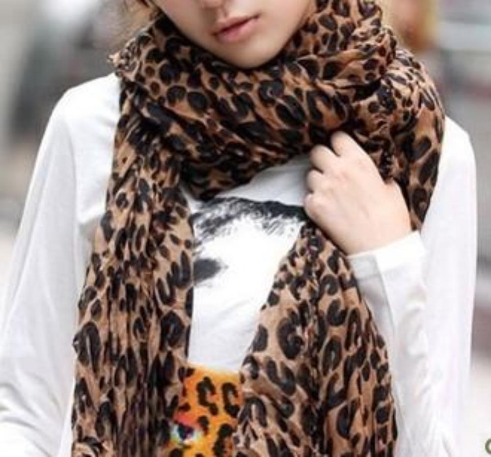 A stylish Women's Chiffon Leopard Print Scarf in brown, showcasing a bold leopard print pattern, perfect for accessorizing any outfit.