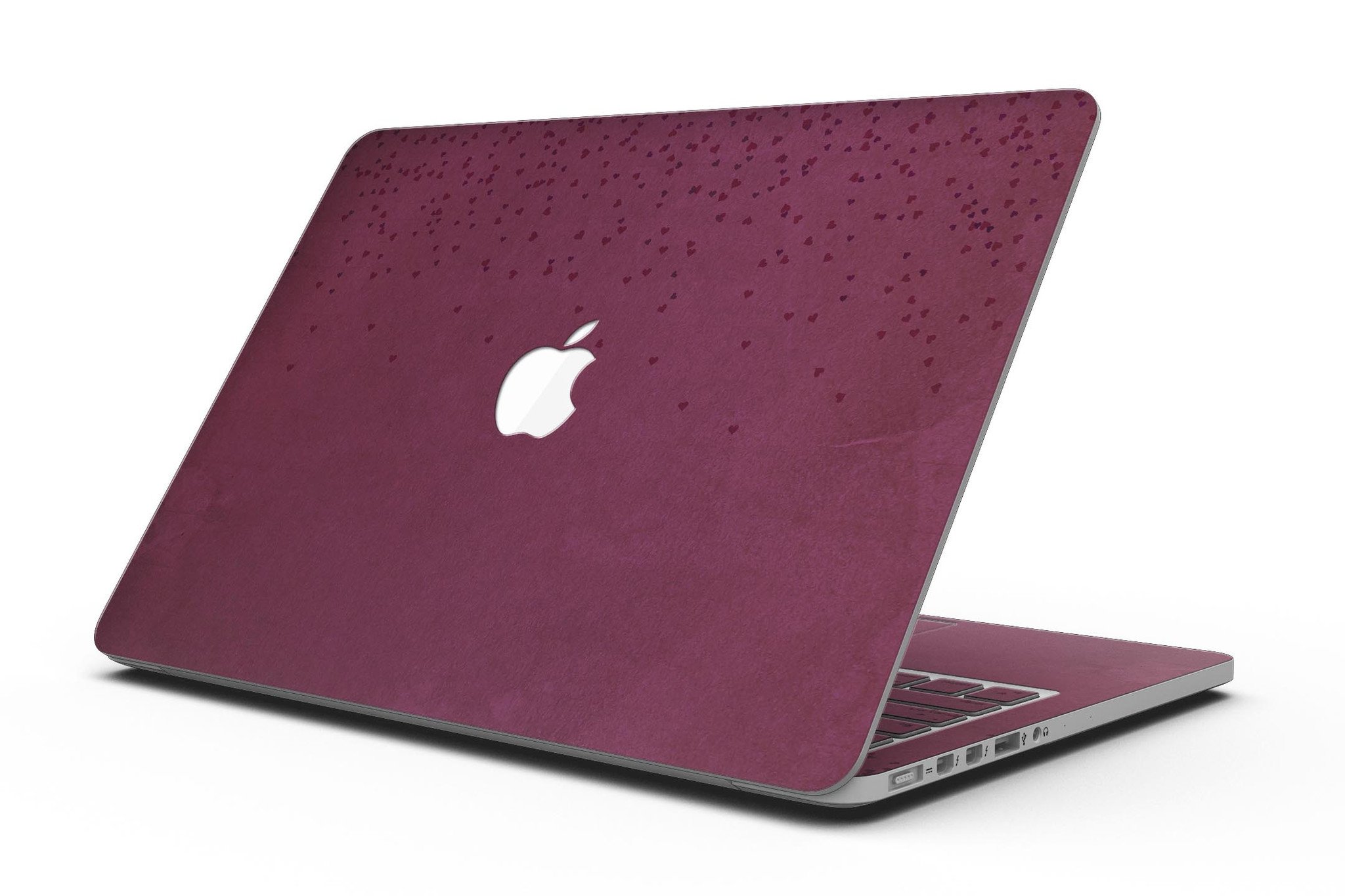 A MacBook Pro with Retina Display covered in a stylish 50 Shades of Burgundy Micro Hearts skin, showcasing intricate heart patterns.