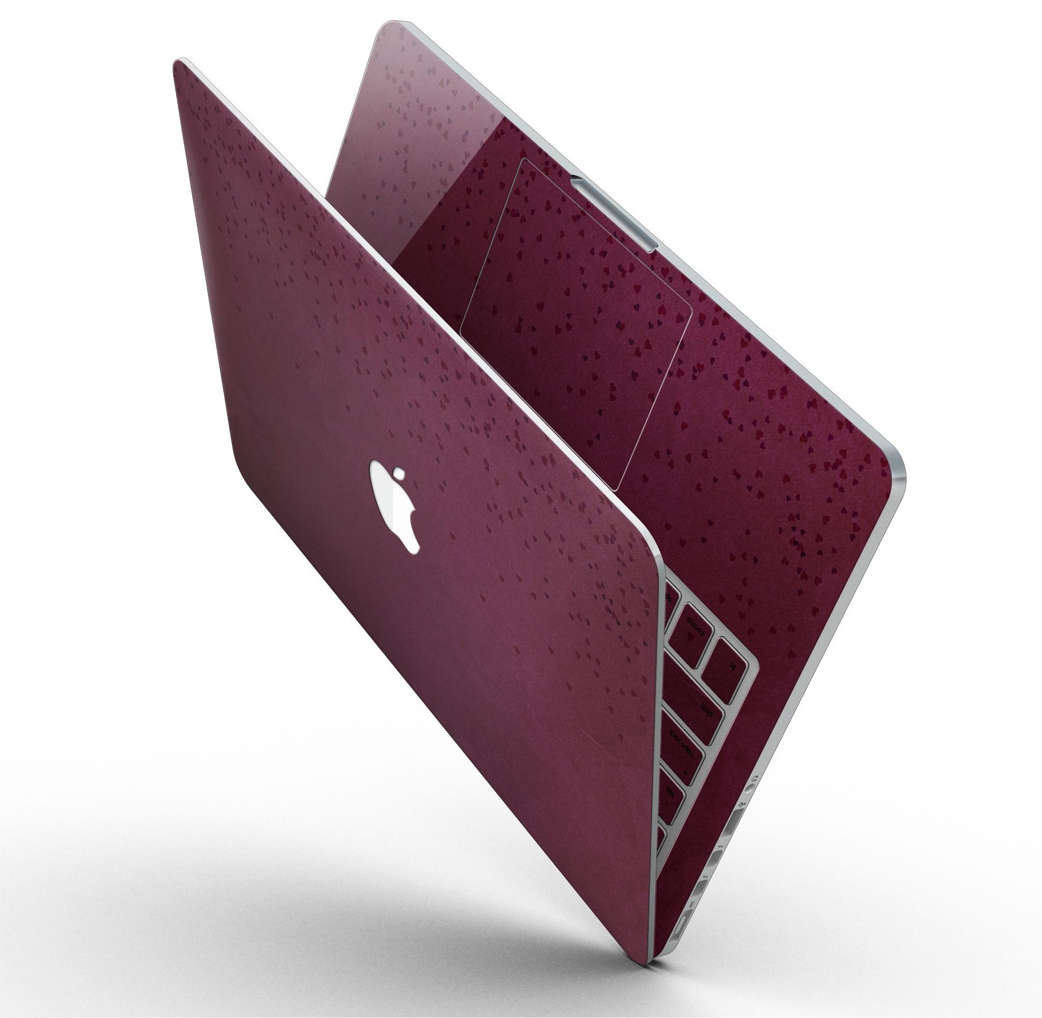 A MacBook Pro with Retina Display covered in a stylish 50 Shades of Burgundy Micro Hearts skin, showcasing intricate heart patterns.