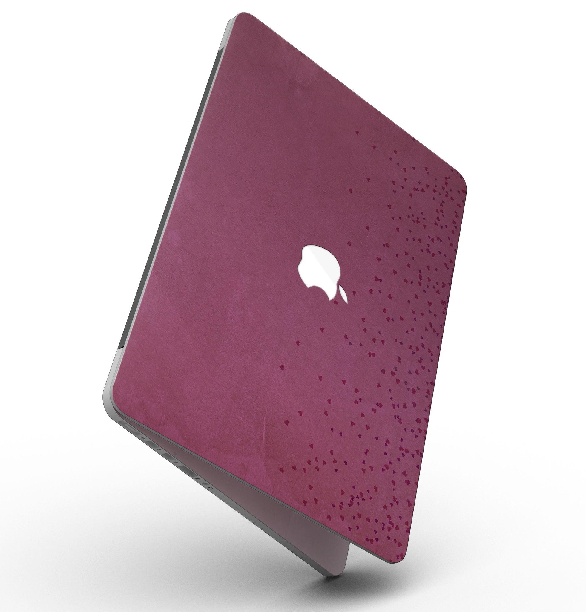 A MacBook Pro with Retina Display covered in a stylish 50 Shades of Burgundy Micro Hearts skin, showcasing intricate heart patterns.