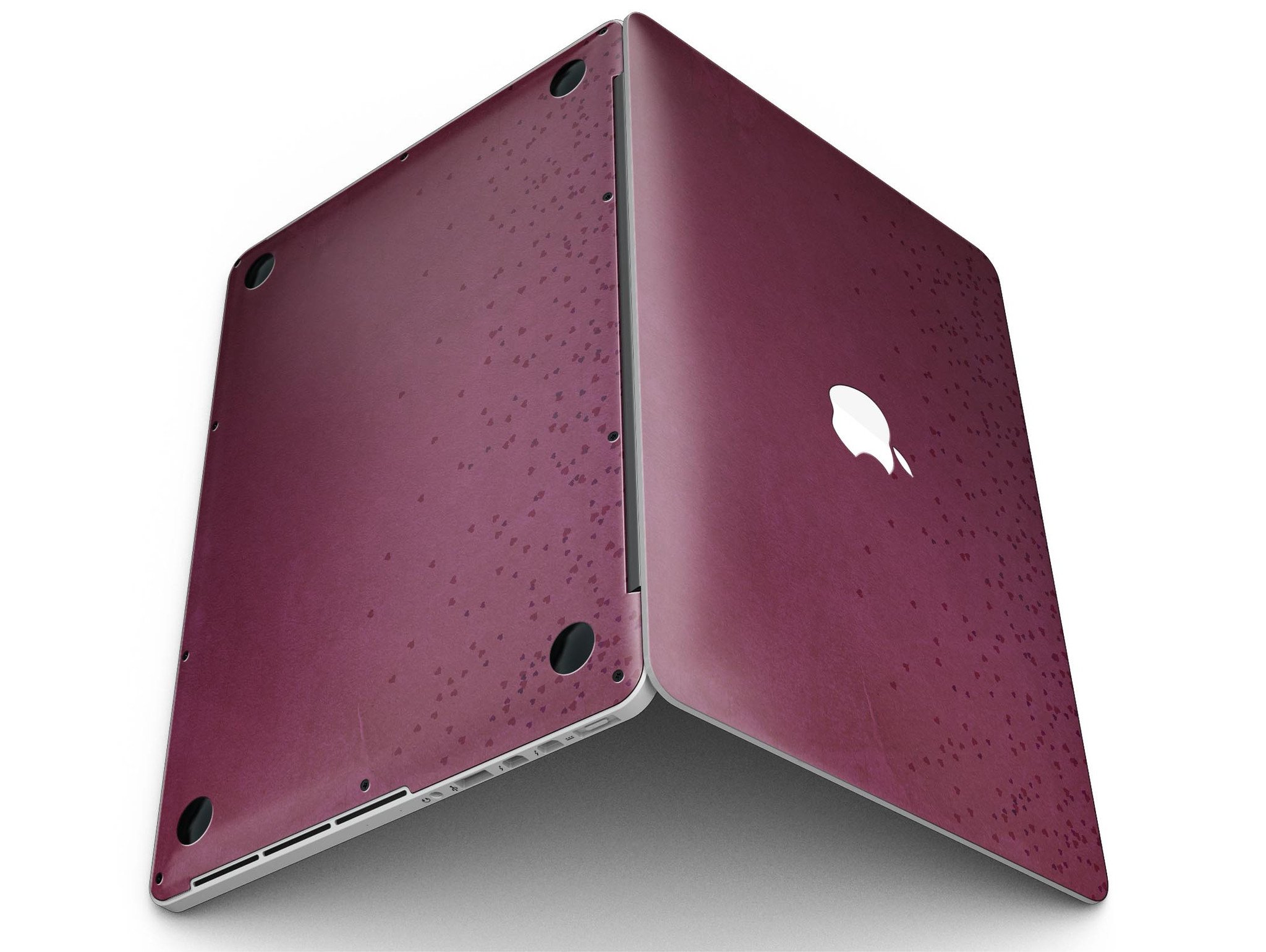 A MacBook Pro with Retina Display covered in a stylish 50 Shades of Burgundy Micro Hearts skin, showcasing intricate heart patterns.