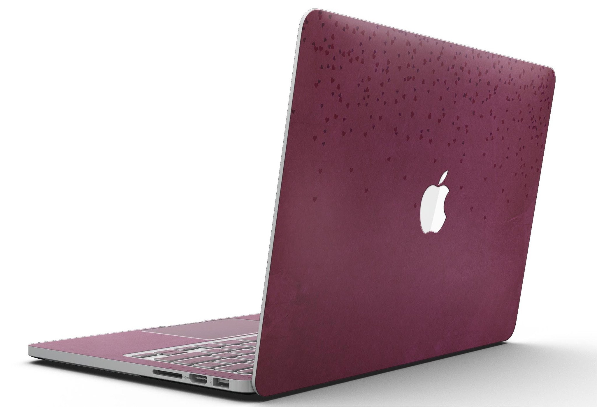 A MacBook Pro with Retina Display covered in a stylish 50 Shades of Burgundy Micro Hearts skin, showcasing intricate heart patterns.