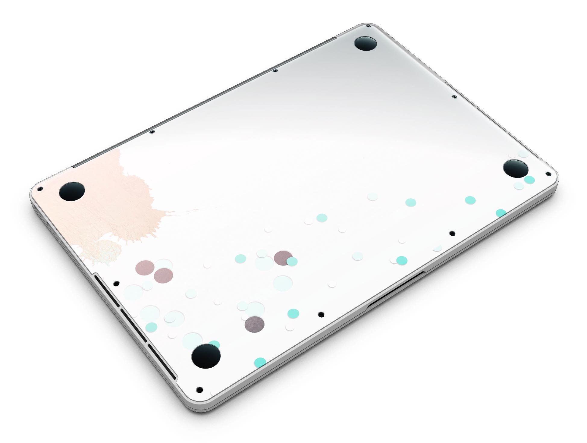 Stylish MacBook Pro skin featuring abstract teal dots and paint spill design, showcasing vibrant colors and a sleek finish.