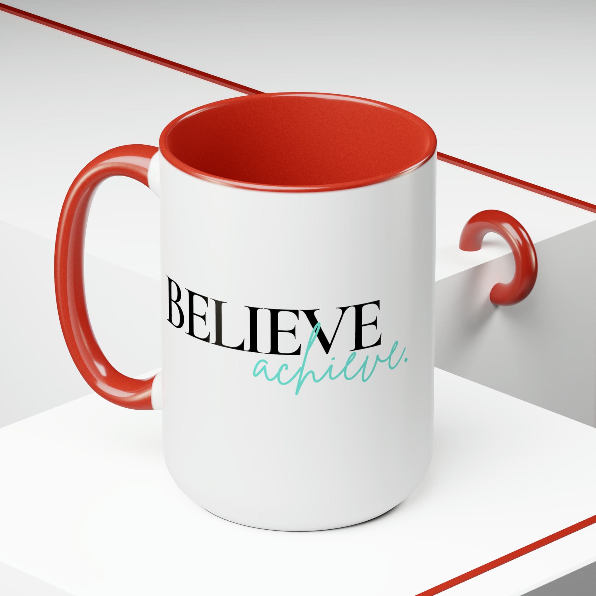 Black ceramic coffee mug with colored interior and handle, featuring the inspirational phrase 'Believe and Achieve'.