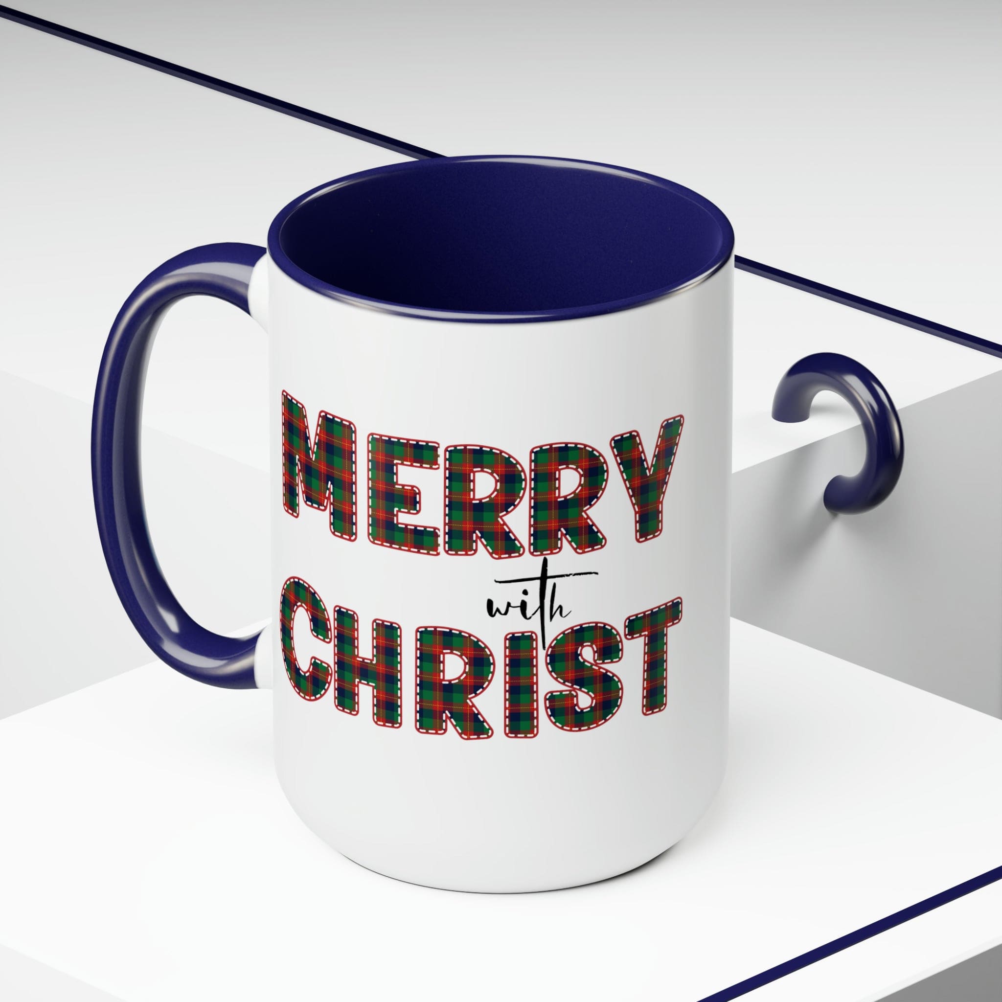 Accent Ceramic Coffee Mug 15oz featuring a Merry with Christ design in red and green plaid, perfect for holiday beverages.