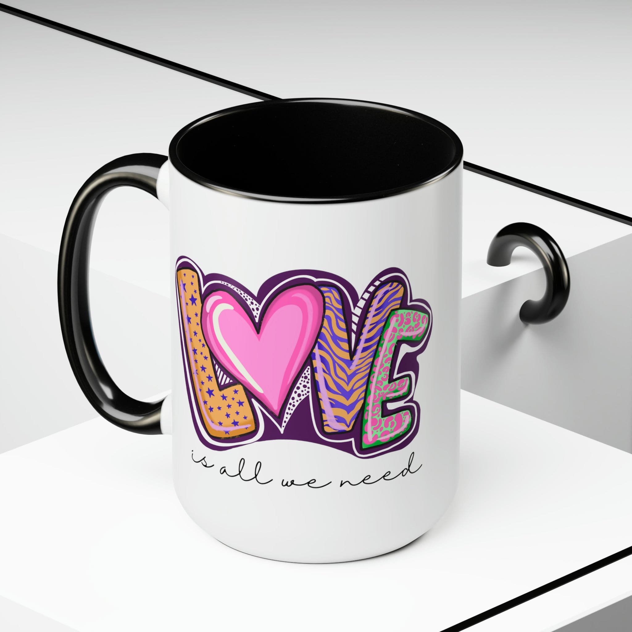 Accent Ceramic Coffee Mug 15oz with a white exterior and colorful interior, featuring the phrase 'Love is All we Need' on the side.