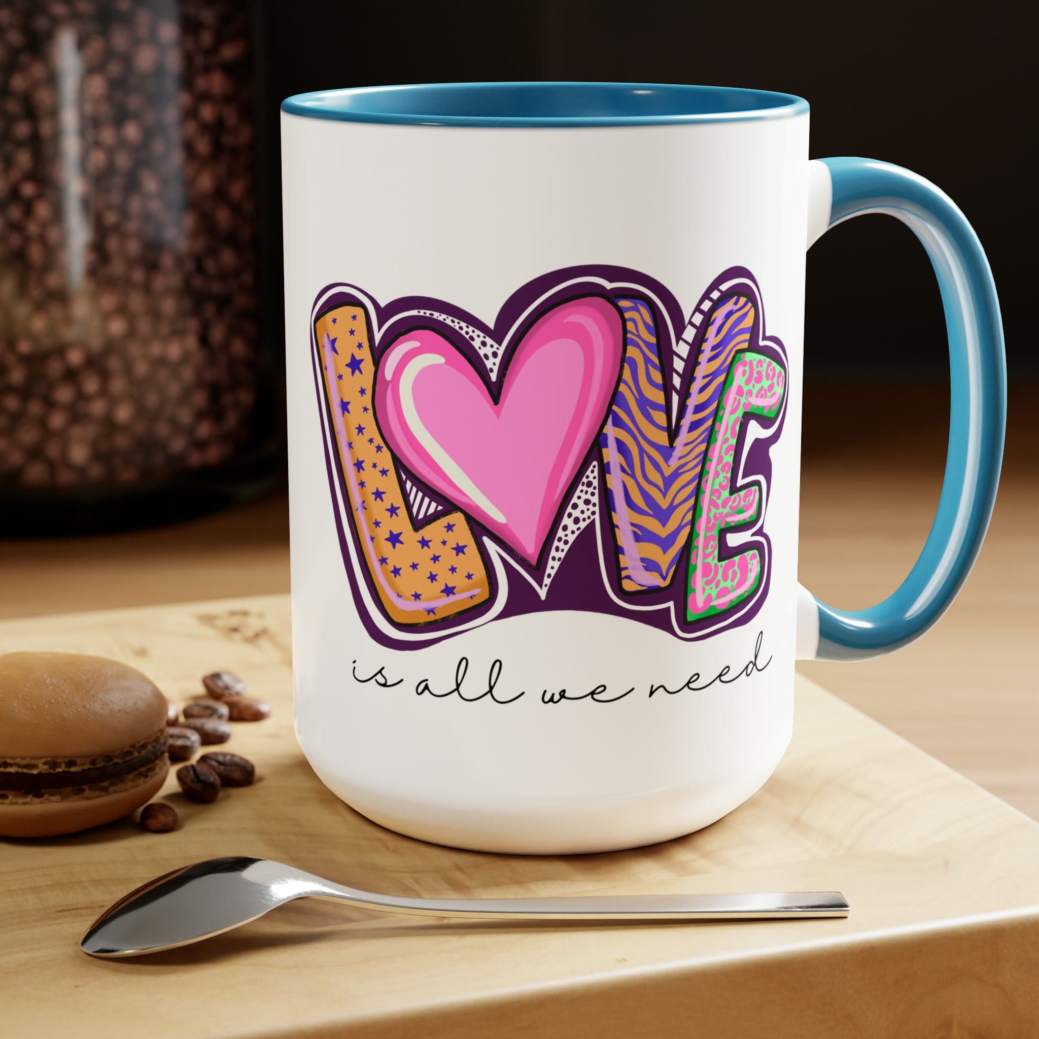 Accent Ceramic Coffee Mug 15oz with a white exterior and colorful interior, featuring the phrase 'Love is All we Need' on the side.