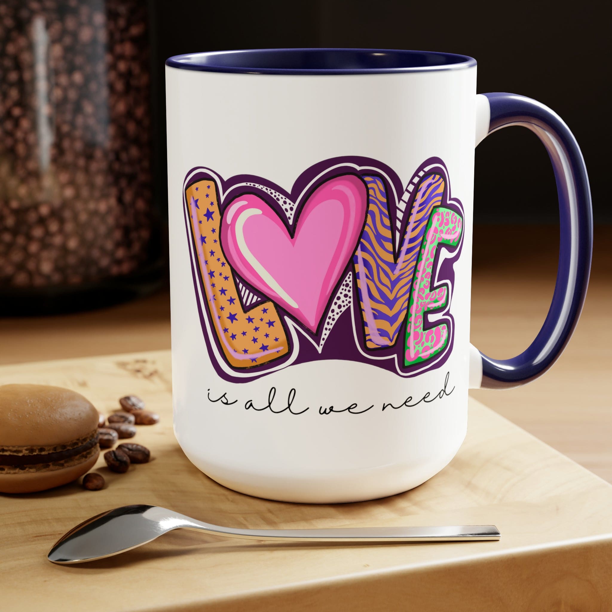 Accent Ceramic Coffee Mug 15oz with a white exterior and colorful interior, featuring the phrase 'Love is All we Need' on the side.