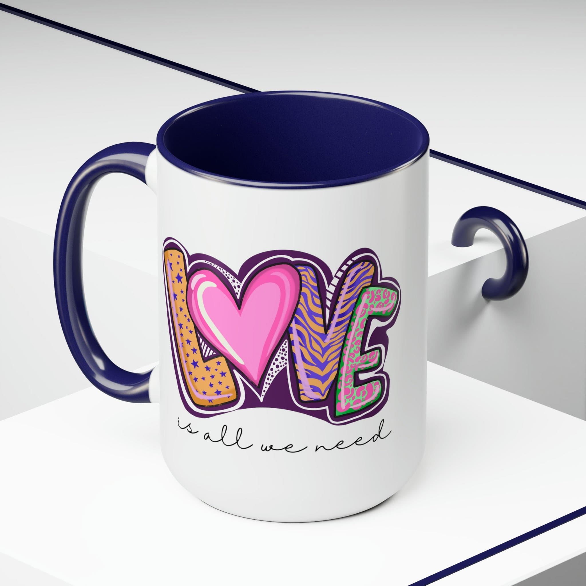 Accent Ceramic Coffee Mug 15oz with a white exterior and colorful interior, featuring the phrase 'Love is All we Need' on the side.