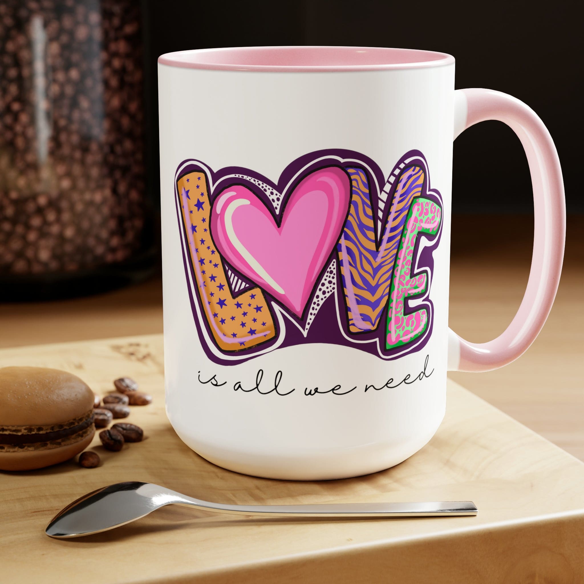 Accent Ceramic Coffee Mug 15oz with a white exterior and colorful interior, featuring the phrase 'Love is All we Need' on the side.