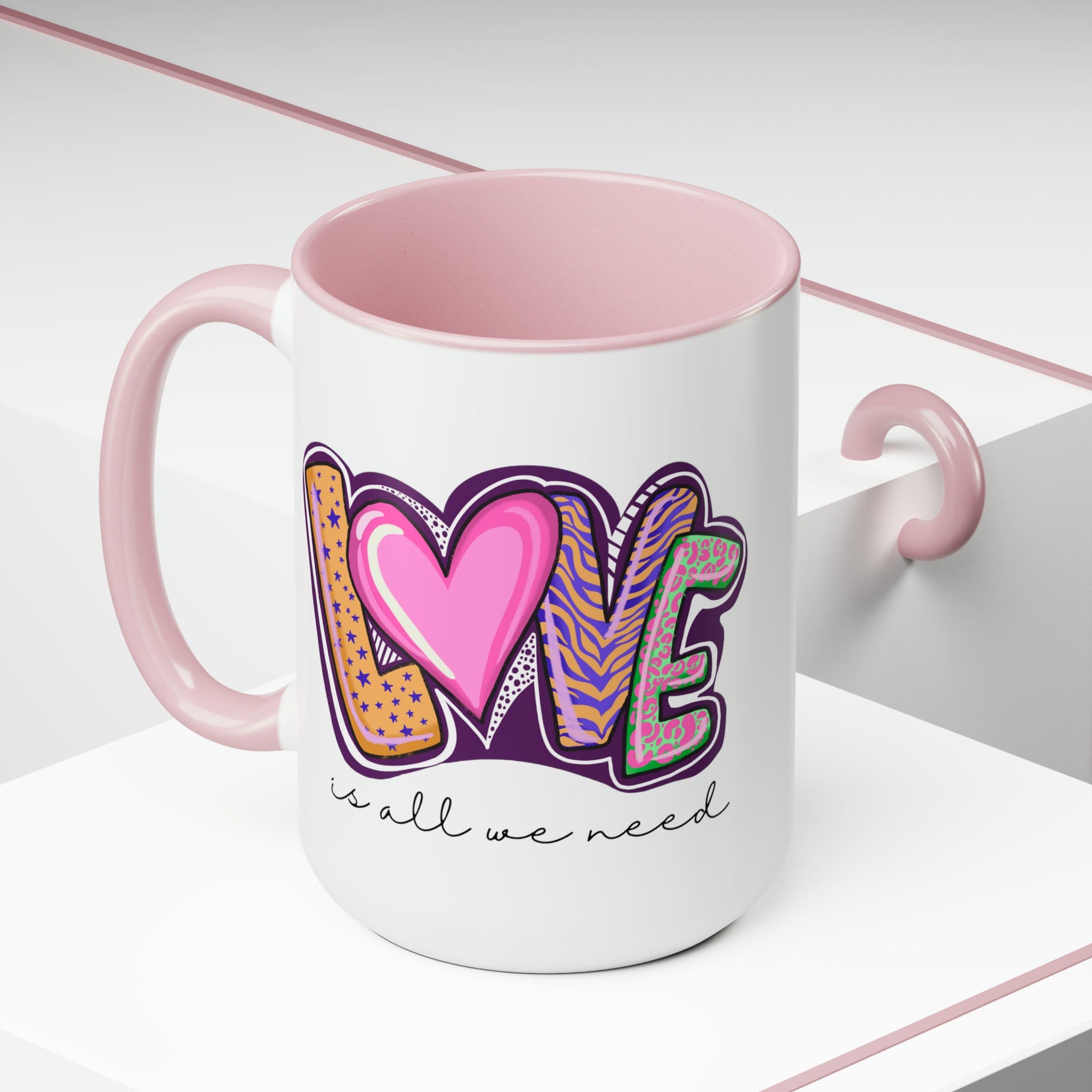 Accent Ceramic Coffee Mug 15oz with a white exterior and colorful interior, featuring the phrase 'Love is All we Need' on the side.