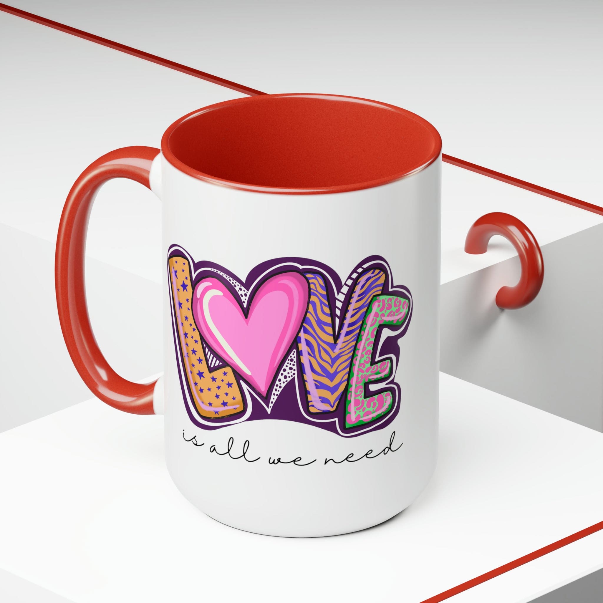 Accent Ceramic Coffee Mug 15oz with a white exterior and colorful interior, featuring the phrase 'Love is All we Need' on the side.