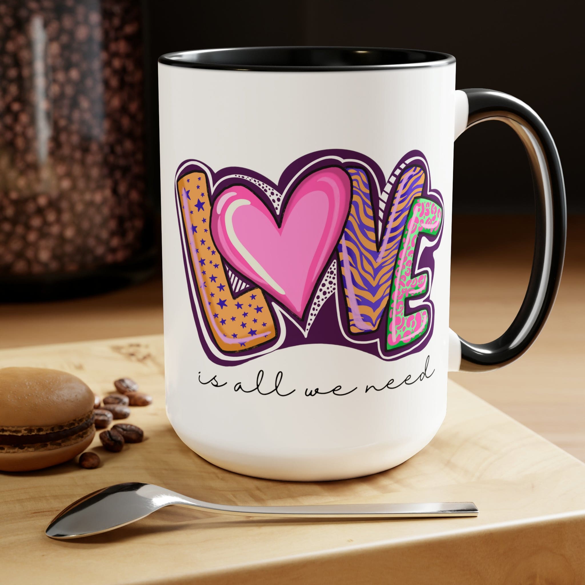 Accent Ceramic Coffee Mug 15oz with a white exterior and colorful interior, featuring the phrase 'Love is All we Need' on the side.