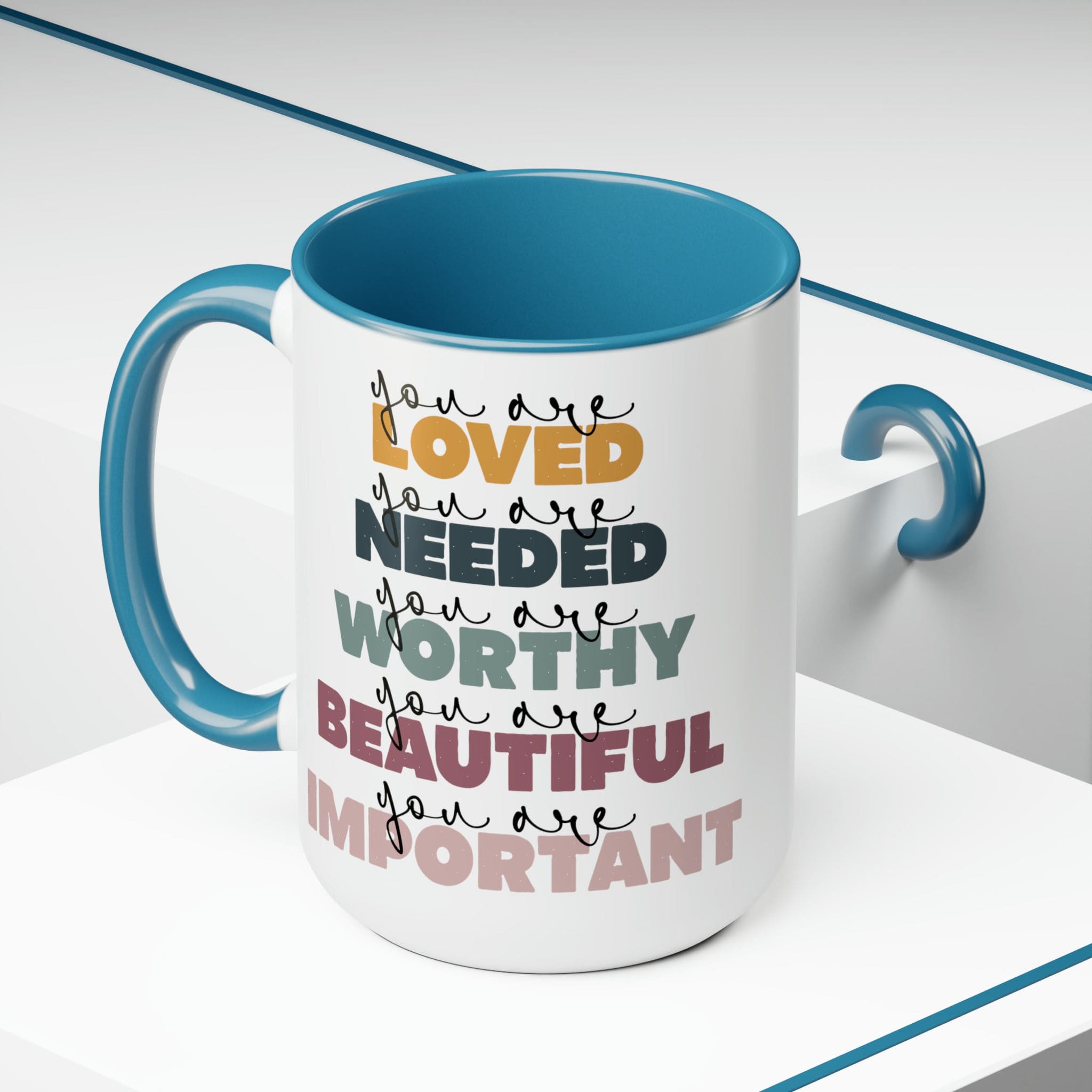 You Are Loved Ceramic Coffee Mug with a white exterior and colored interior, featuring a C-handle and inspirational message.