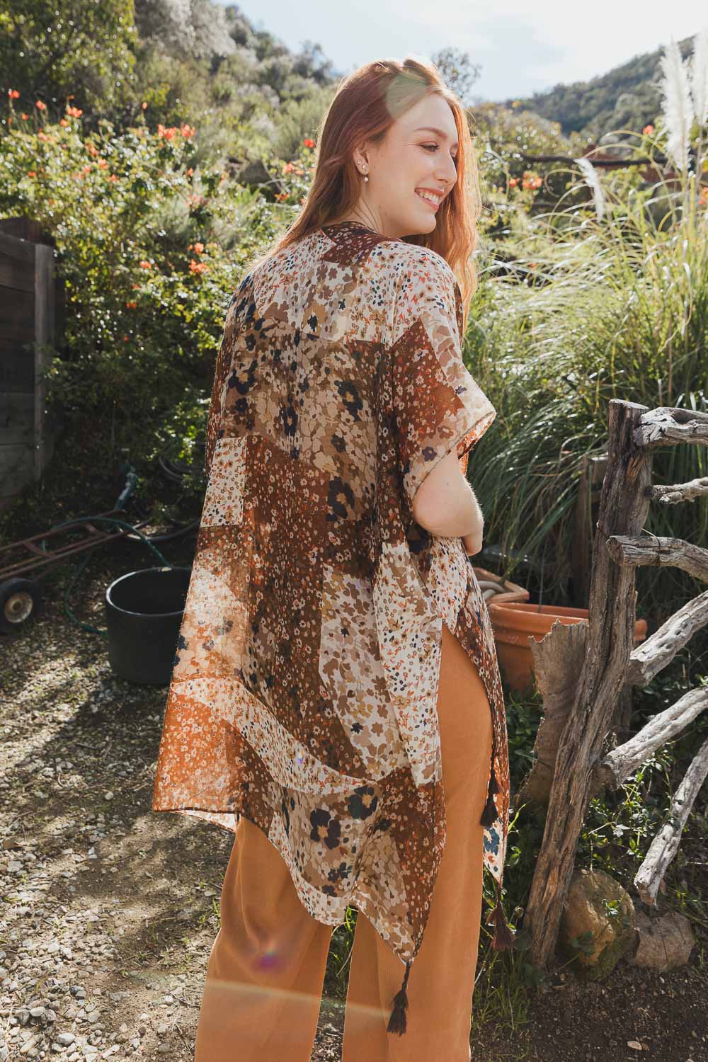 A stylish Allover Floral Print Kimono featuring vibrant floral patterns, lightweight fabric, and loose structured sleeves, perfect for layering.