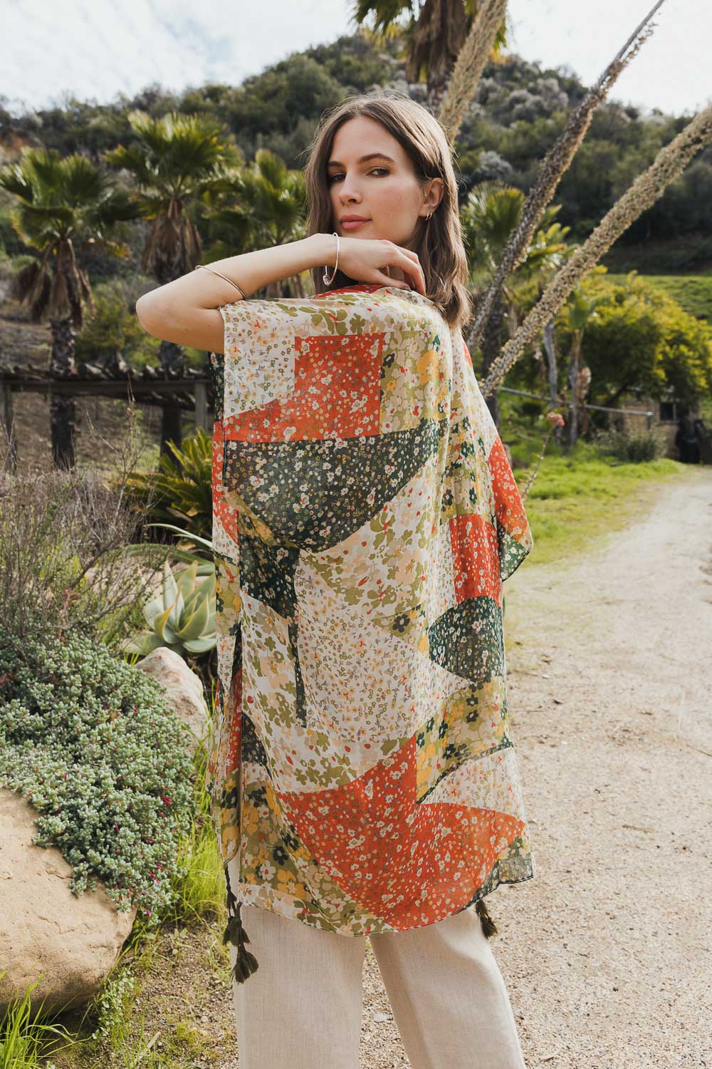 A stylish Allover Floral Print Kimono featuring vibrant floral patterns, lightweight fabric, and loose structured sleeves, perfect for layering.