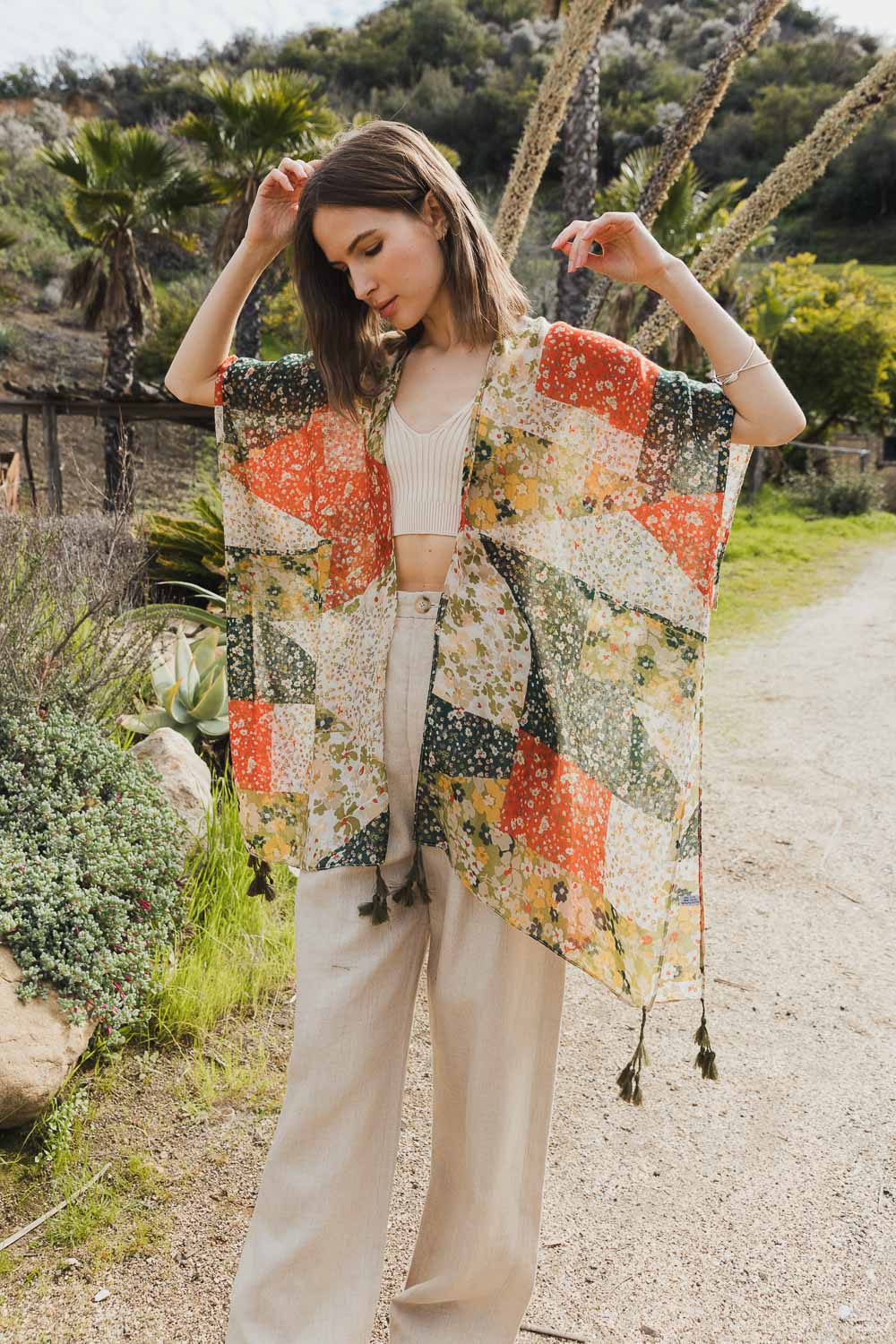 A stylish Allover Floral Print Kimono featuring vibrant floral patterns, lightweight fabric, and loose structured sleeves, perfect for layering.