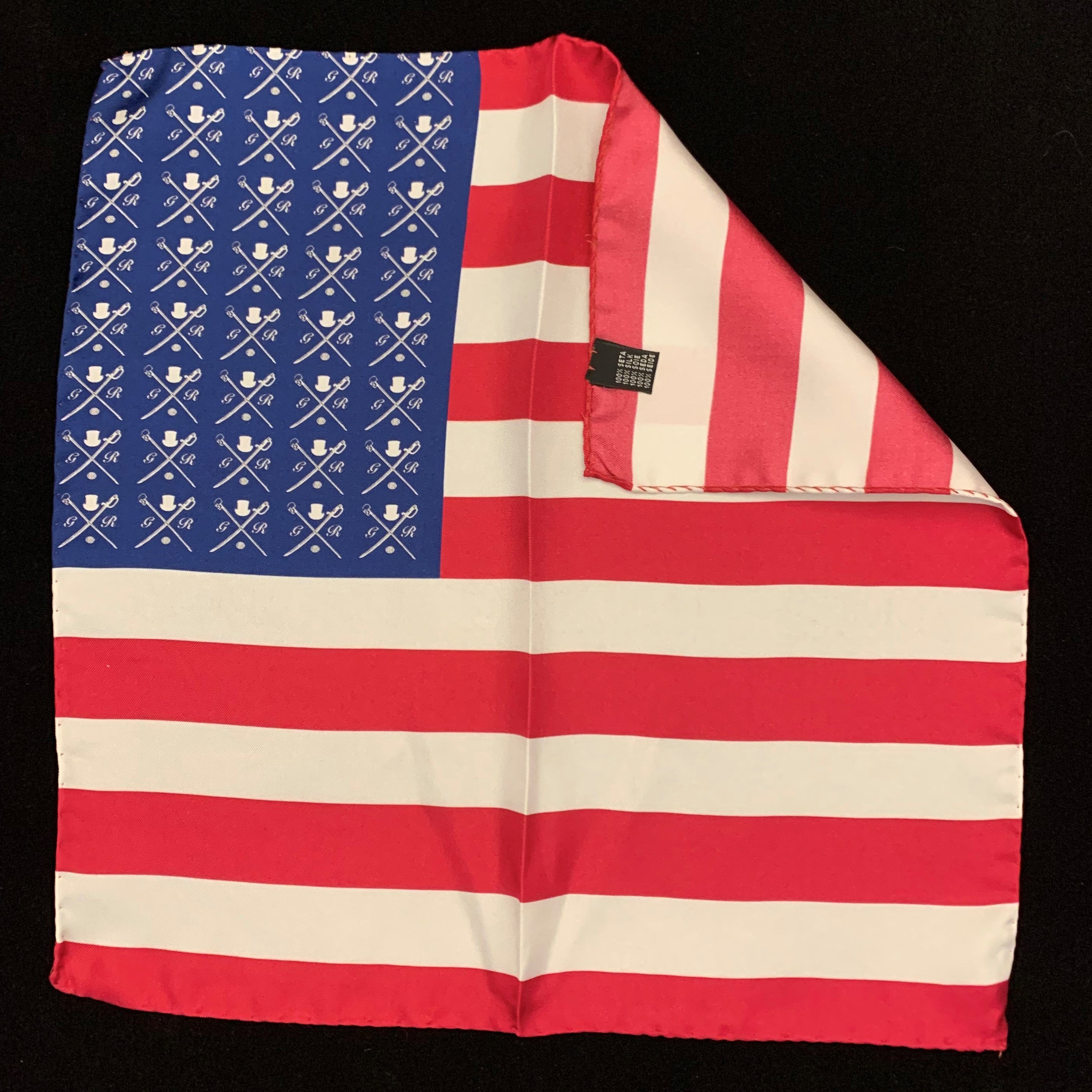 American Rogue Pocket Square featuring a vibrant American flag design in red, white, and blue, made from luxurious silk.