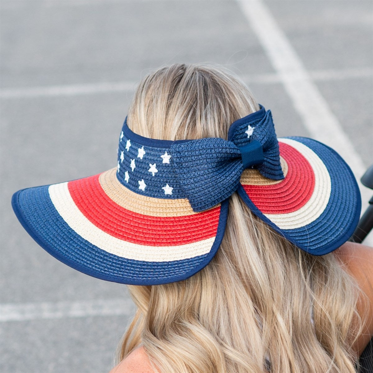 Americana Patriotic Rollable Visor featuring a decorative bow and adjustable strap, perfect for outdoor activities and 4th of July celebrations.