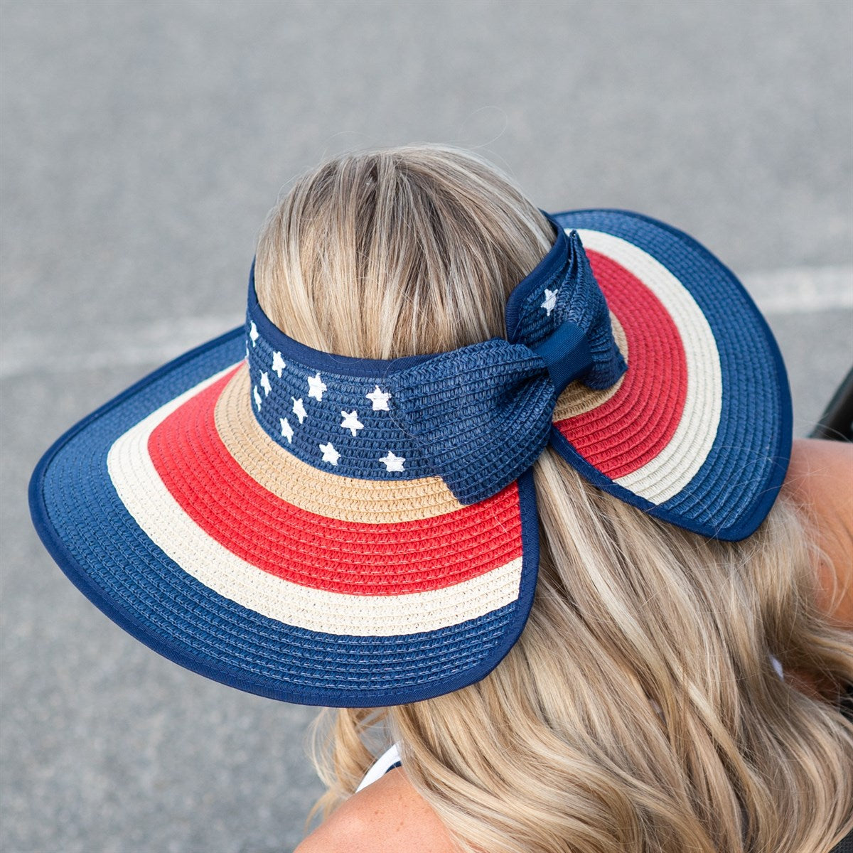 Americana Patriotic Rollable Visor featuring a decorative bow and adjustable strap, perfect for outdoor activities and 4th of July celebrations.