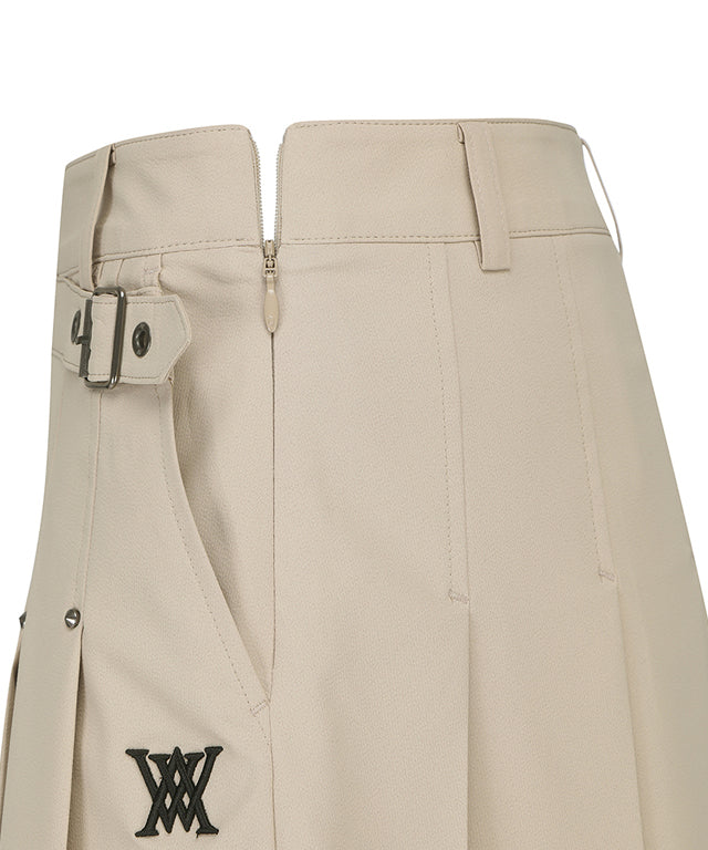 ANEW Golf Women's Buckle Decoration Pleats Skirt in Beige, showcasing pleats and buckle details.