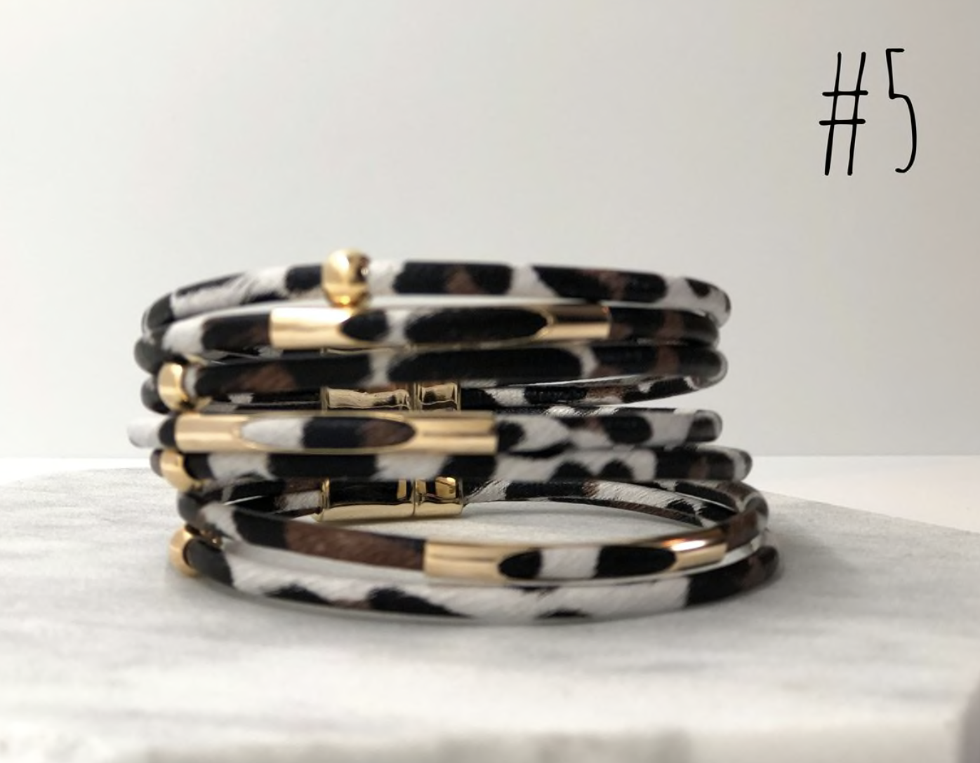 A stylish collection of animal print wrap bracelets featuring various patterns and colors, showcasing their unique design and magnetic closure.