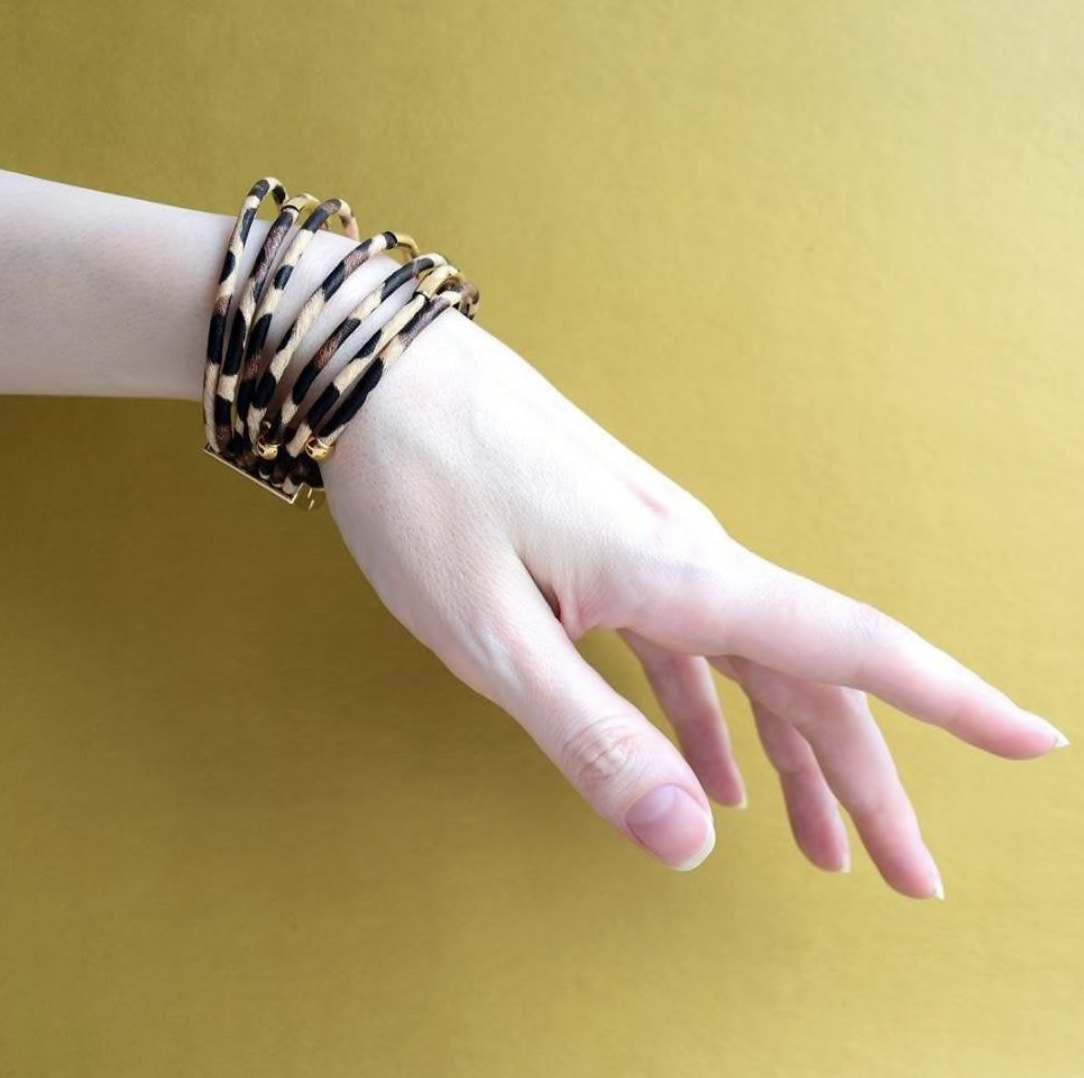 A stylish collection of animal print wrap bracelets featuring various patterns and colors, showcasing their unique design and magnetic closure.