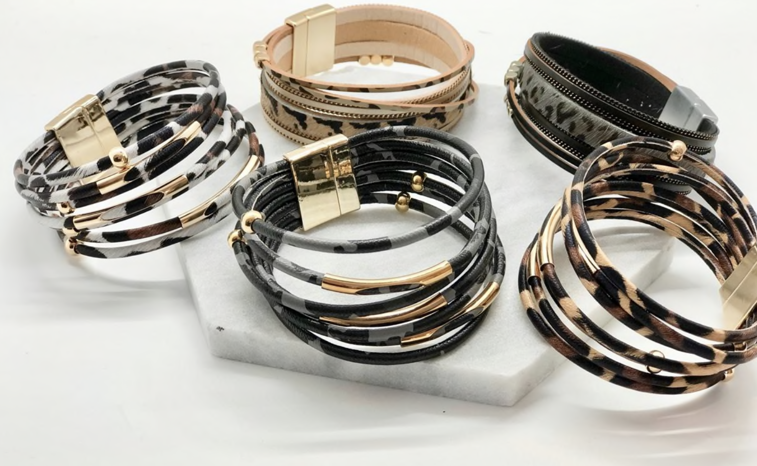 A stylish collection of animal print wrap bracelets featuring various patterns and colors, showcasing their unique design and magnetic closure.