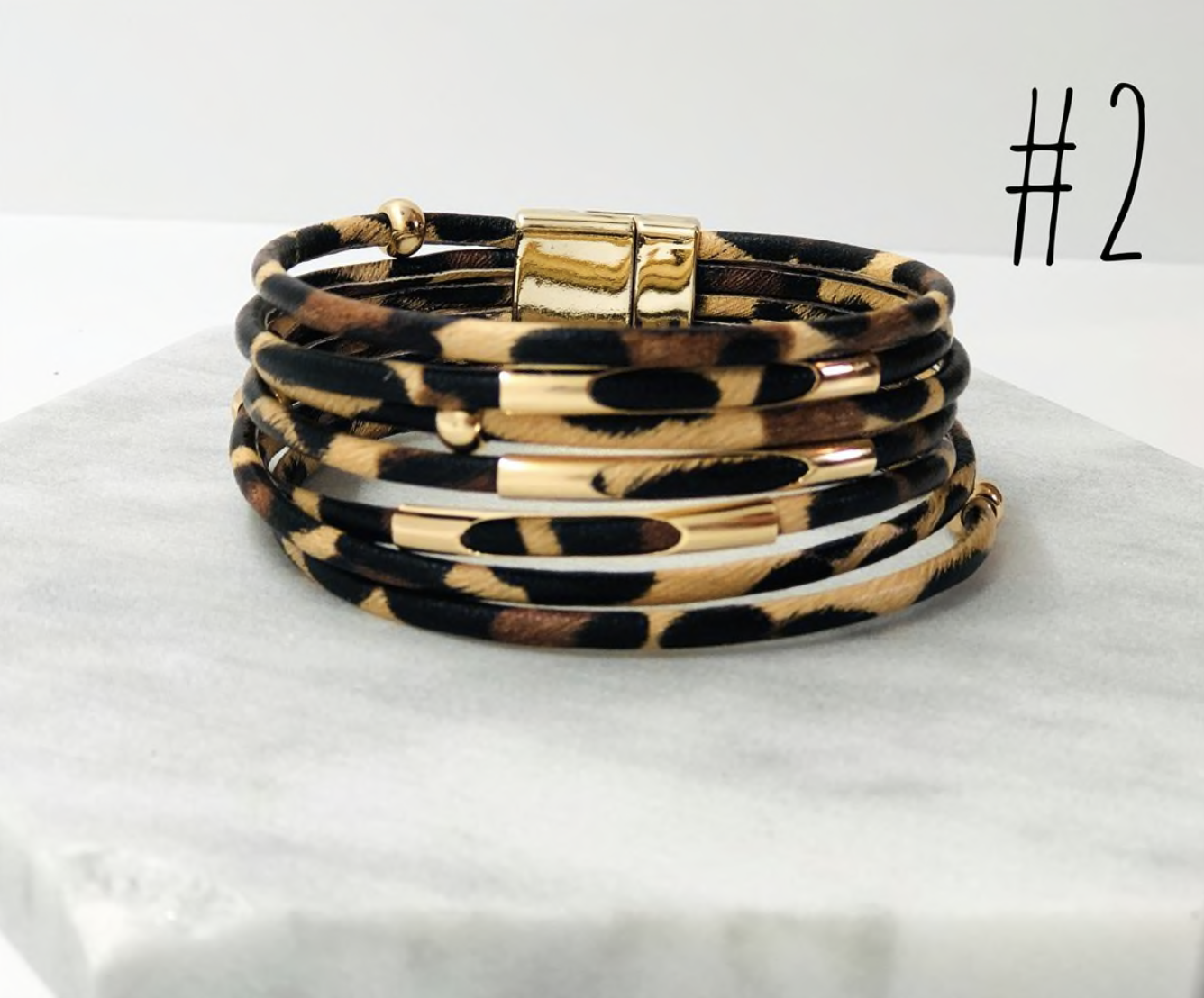 A stylish collection of animal print wrap bracelets featuring various patterns and colors, showcasing their unique design and magnetic closure.