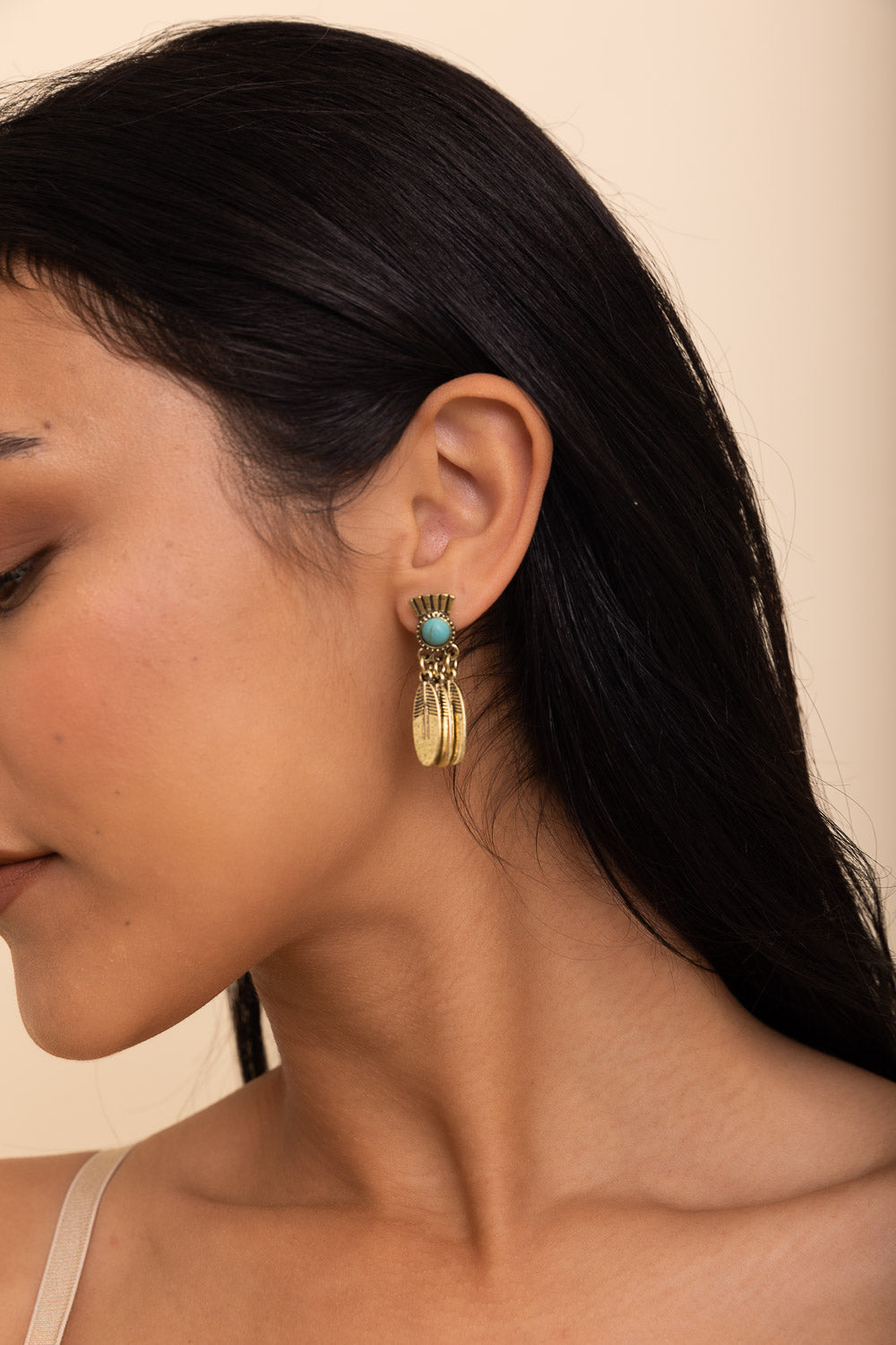 Antique bronze earrings featuring vibrant turquoise stones, showcasing a vintage design.