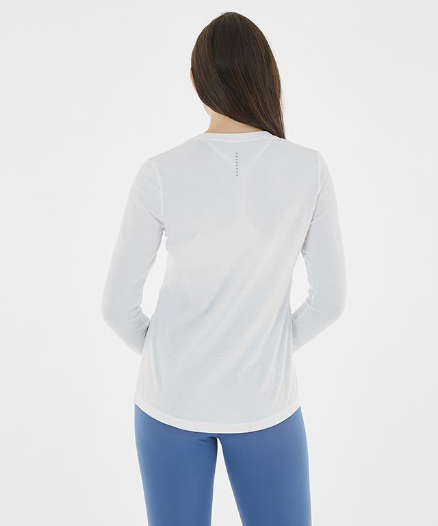 A stylish Anytime Long Sleeve shirt featuring a relaxed fit, diagonal waistline, and reflective tape details.