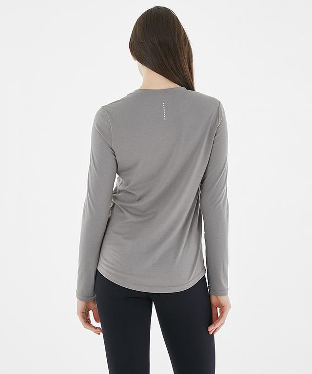 A stylish Anytime Long Sleeve shirt featuring a relaxed fit, diagonal waistline, and reflective tape details.