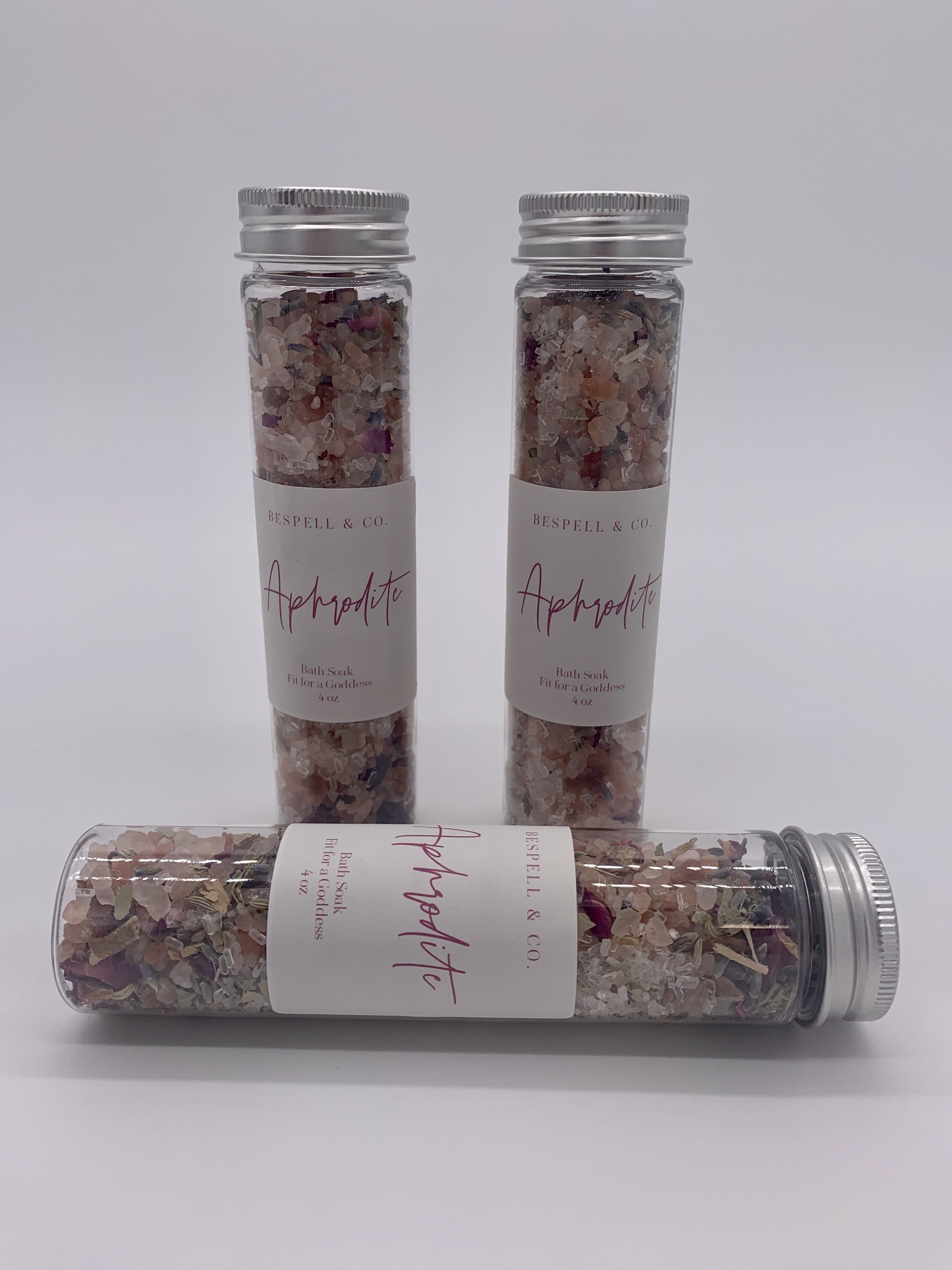 Aphrodite Bath Soak in a decorative jar with pink Himalayan salt and herbs, perfect for a luxurious bath experience.