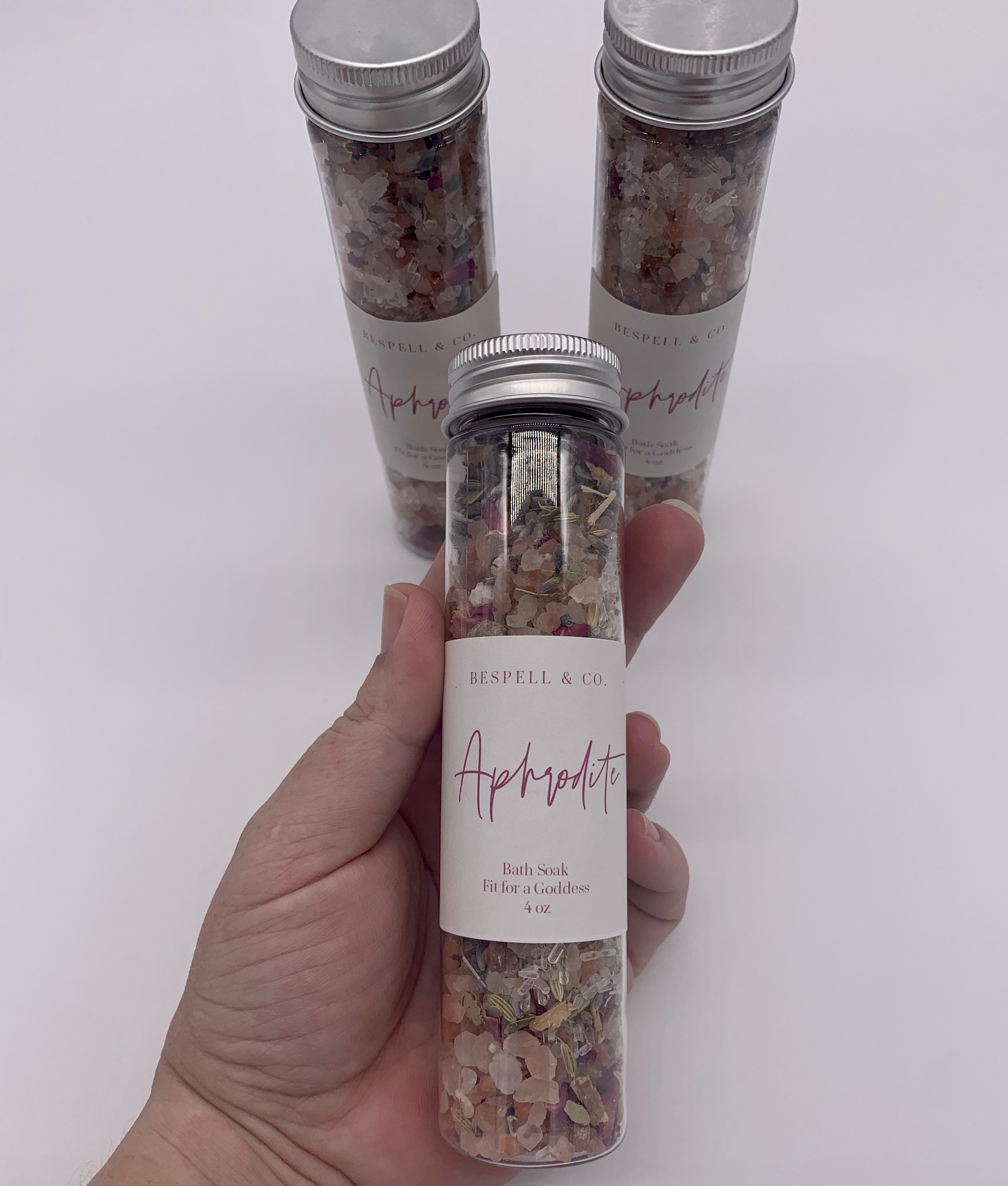 Aphrodite Bath Soak in a decorative jar with pink Himalayan salt and herbs, perfect for a luxurious bath experience.