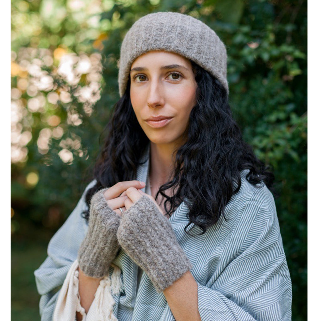 A pair of Autumn Ribbed Alpaca Gloves showcasing a fingerless design, crafted from soft baby alpaca fiber with a ribbed texture, perfect for chilly weather.