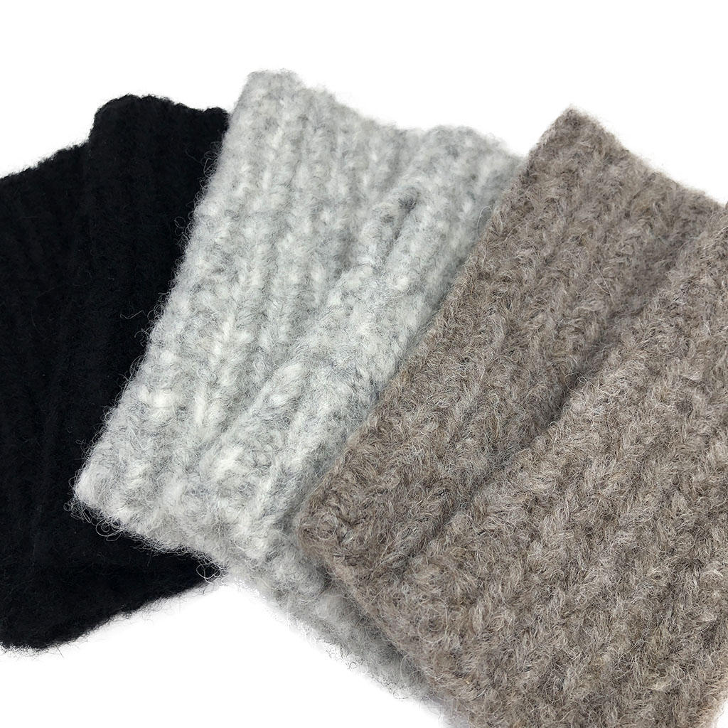 A pair of Autumn Ribbed Alpaca Gloves showcasing a fingerless design, crafted from soft baby alpaca fiber with a ribbed texture, perfect for chilly weather.