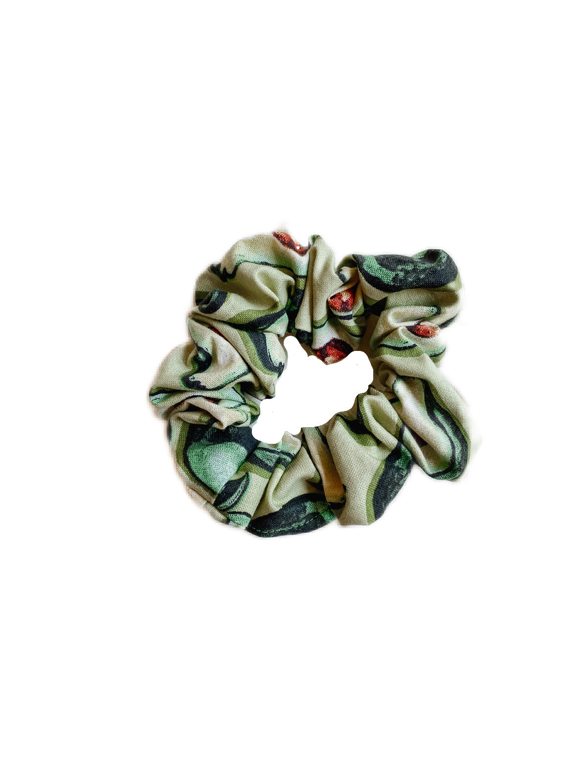 A soft cotton scrunchie featuring a playful avocado design, perfect for securing hair in style.