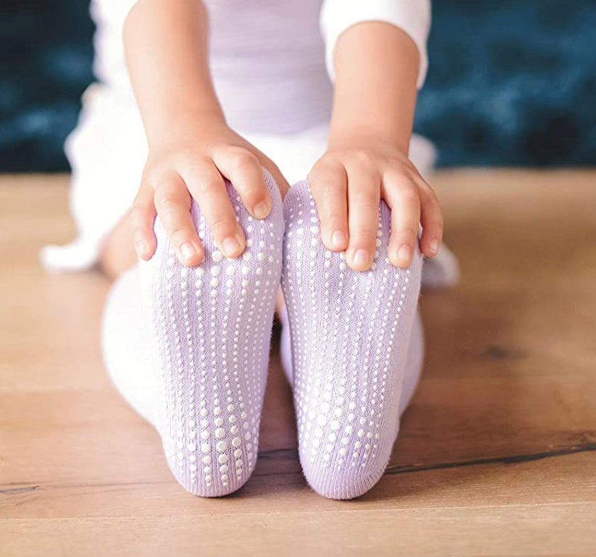 A colorful assortment of Baby Toddler Non-Slip Knee High Grip Socks, showcasing various patterns and colors designed for comfort and safety.