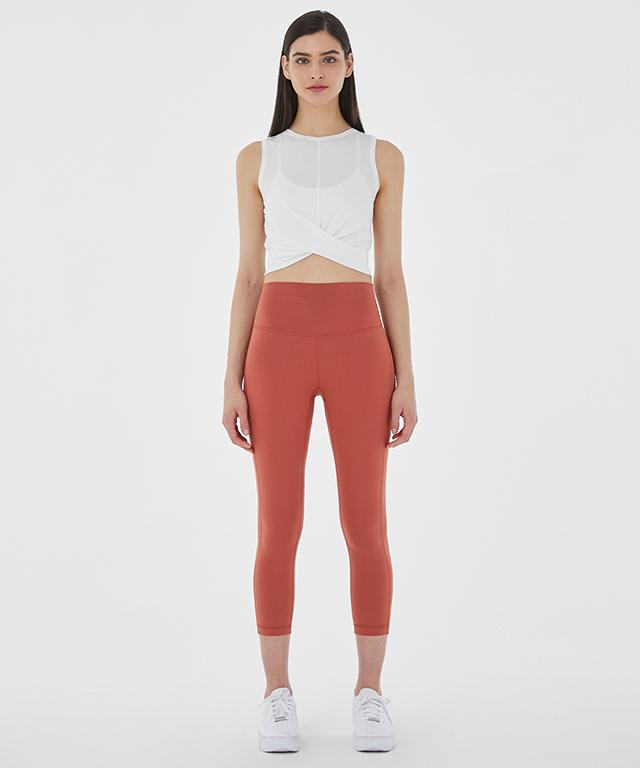 A stylish Balance Tank featuring a twist front design and cropped silhouette, perfect for layering with sports bras.