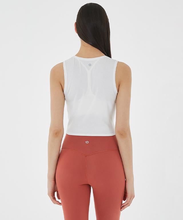 A stylish Balance Tank featuring a twist front design and cropped silhouette, perfect for layering with sports bras.