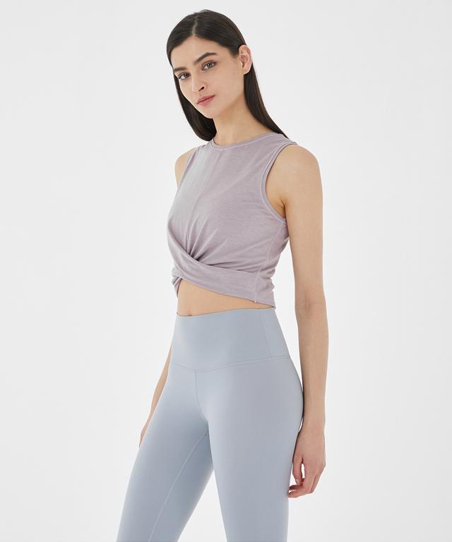 A stylish Balance Tank featuring a twist front design and cropped silhouette, perfect for layering with sports bras.