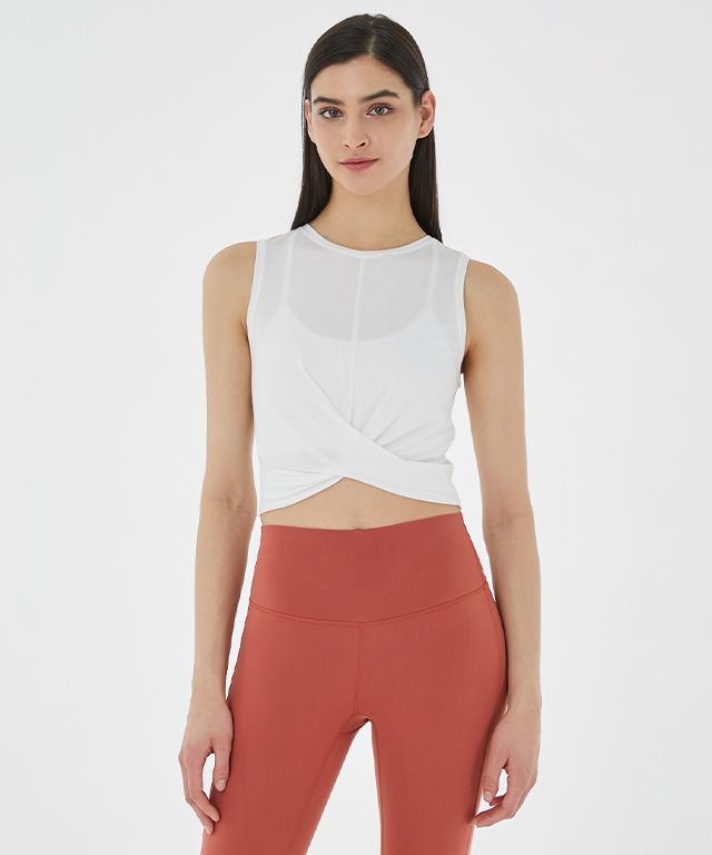 A stylish Balance Tank featuring a twist front design and cropped silhouette, perfect for layering with sports bras.