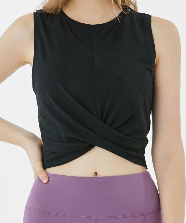 A stylish Balance Tank featuring a twist front design and cropped silhouette, perfect for layering with sports bras.