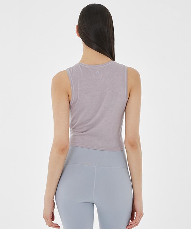 A stylish Balance Tank featuring a twist front design and cropped silhouette, perfect for layering with sports bras.