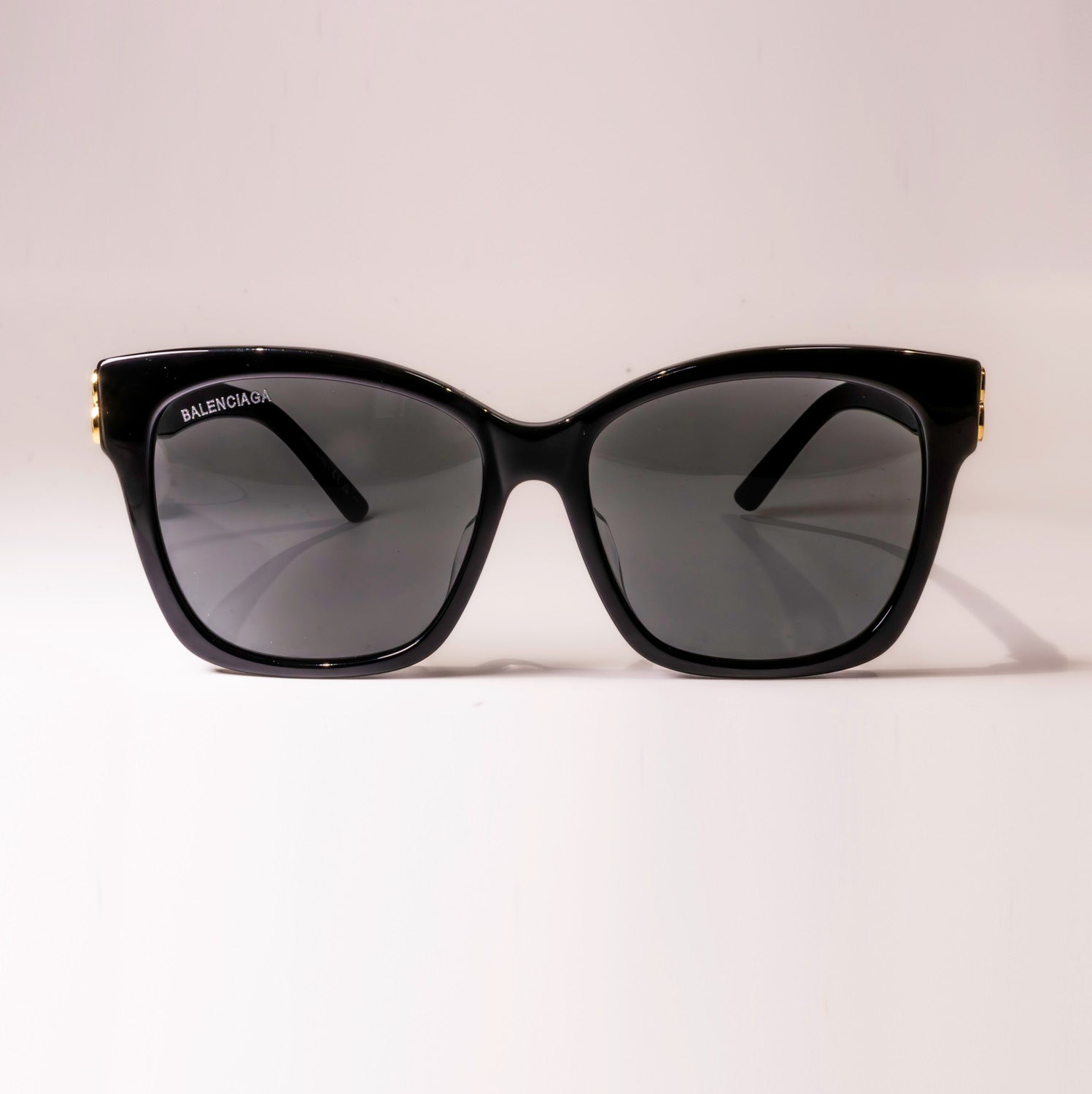 BALENCIAGA SUNGLASSES BB0102SA 001 with black frame and grey shiny lenses, showcasing luxury and style.