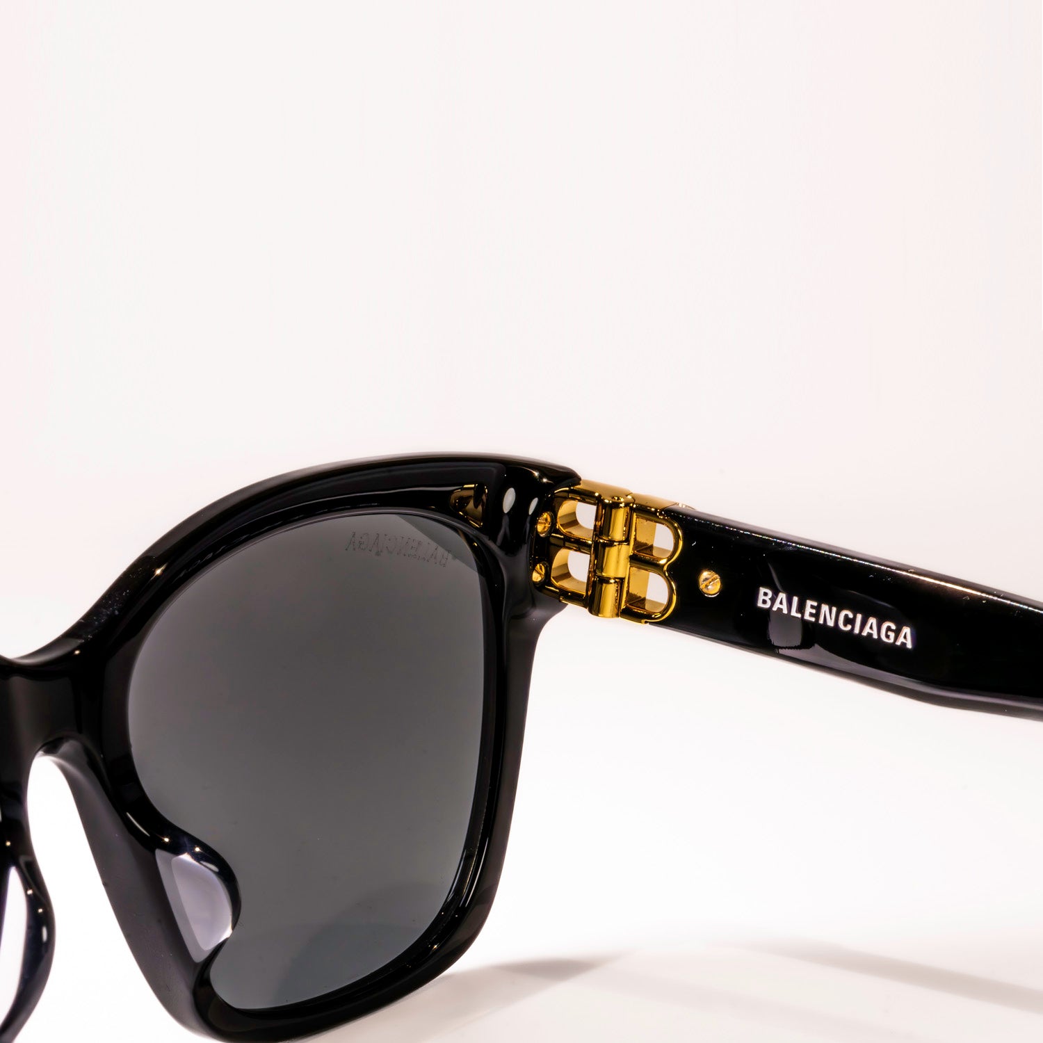 BALENCIAGA SUNGLASSES BB0102SA 001 with black frame and grey shiny lenses, showcasing luxury and style.