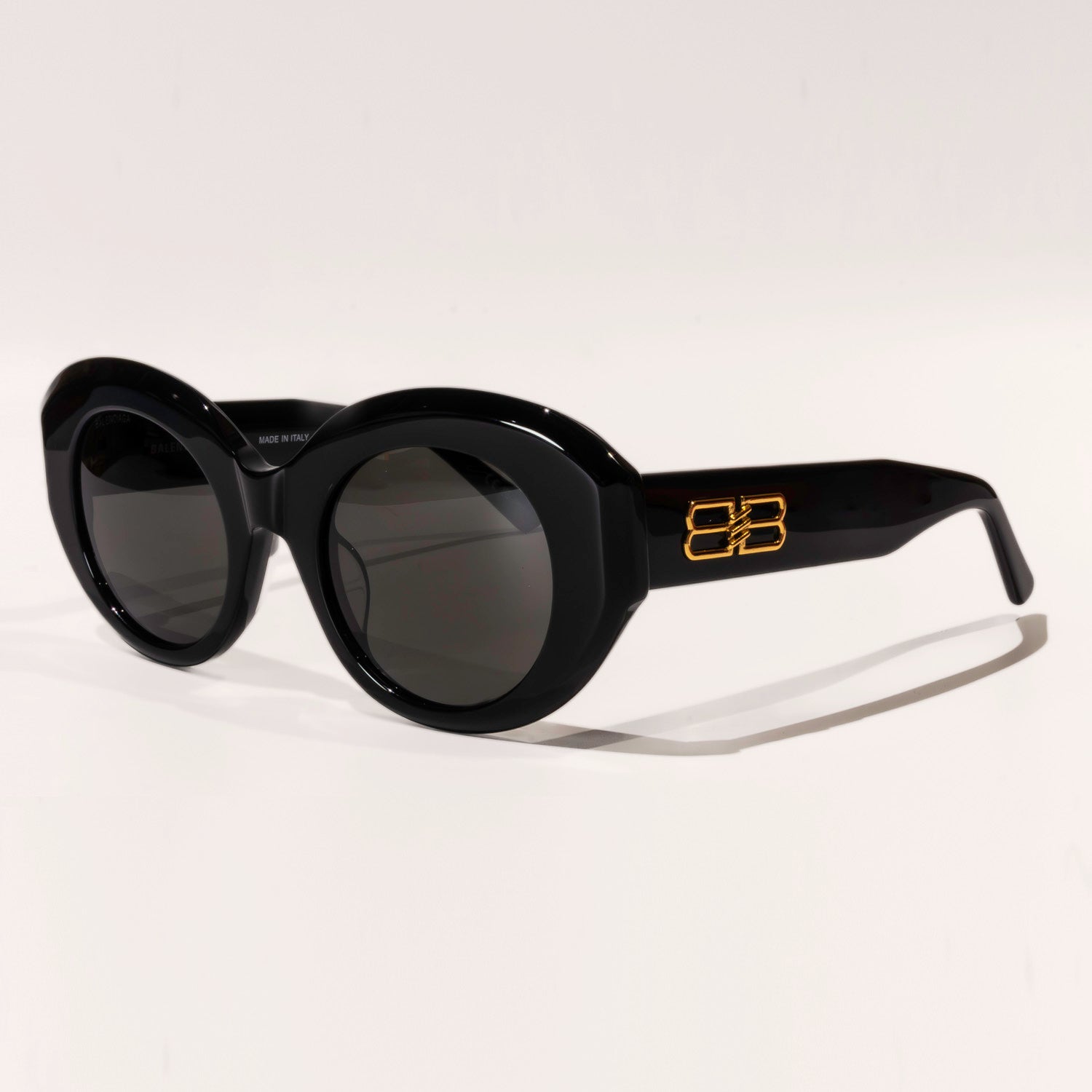 BALENCIAGA SUNGLASSES BB0235S featuring round brown or black lenses and a full rim acetate frame, stylishly displayed in a protective case.